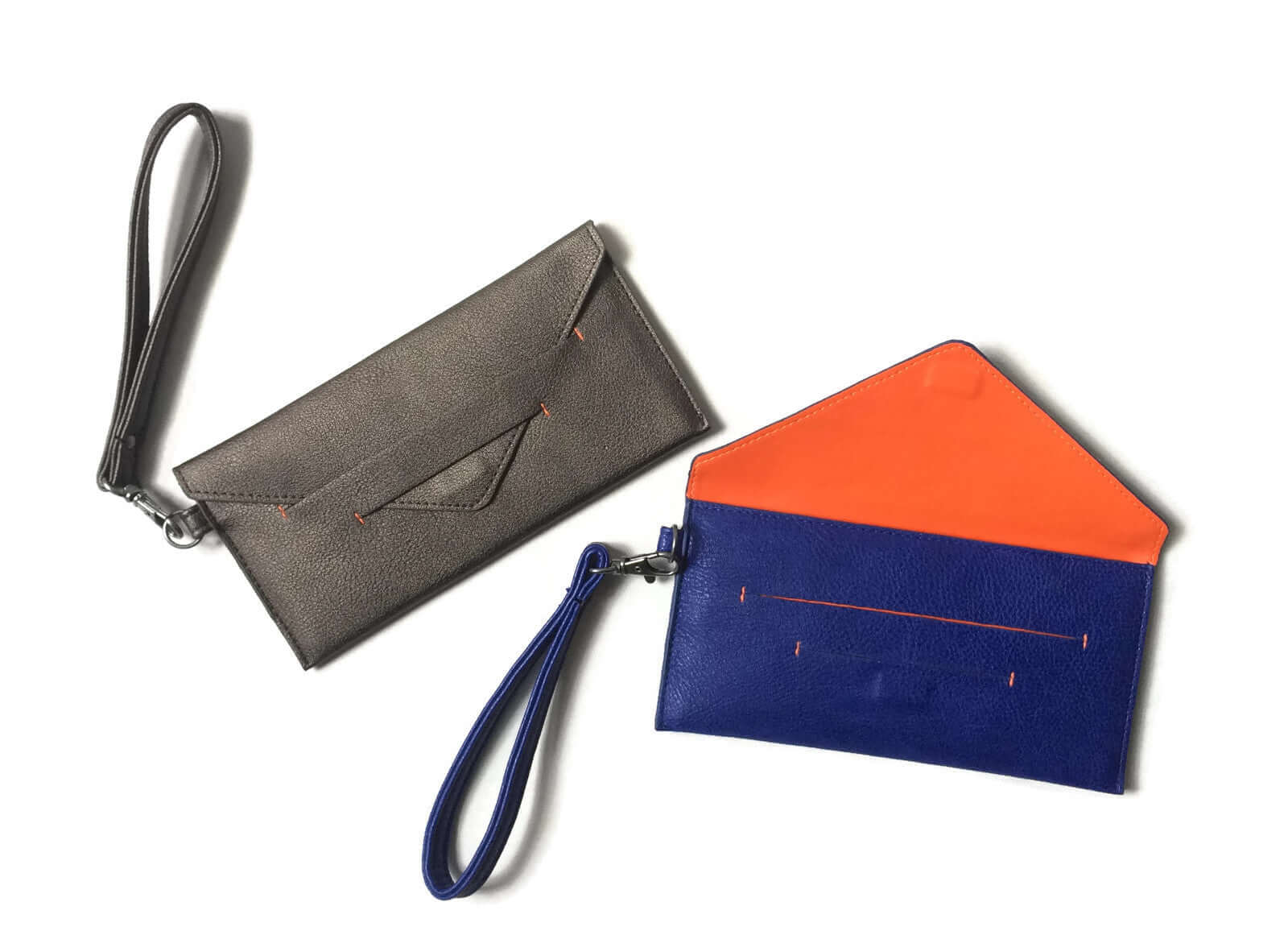 Delancey Vegan Wallet in grey and blue, showing hidden magnet closure and detachable wrist strap, made from supple vegan leather.